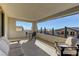 Spacious covered balcony with comfortable seating and scenic neighborhood views, perfect for outdoor relaxation and entertaining at 12121 Cabo Rojo Ave, Las Vegas, NV 89138