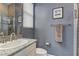Well-lit bathroom features a granite vanity, framed mirror, and a tiled shower with glass enclosure for modern living at 12121 Cabo Rojo Ave, Las Vegas, NV 89138