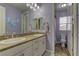 Bright bathroom featuring double sinks with granite counters and lavender walls, exuding a clean, modern style at 12121 Cabo Rojo Ave, Las Vegas, NV 89138