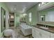 Elegant bathroom with a freestanding tub, dual vanities, and a tiled shower area offering a spa-like experience at 12121 Cabo Rojo Ave, Las Vegas, NV 89138