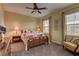 Cozy bedroom features a floral comforter, warm lighting, and dual windows creating an inviting, comfortable space at 12121 Cabo Rojo Ave, Las Vegas, NV 89138