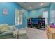 Playful bonus room features bright blue walls, comfortable seating, and entertainment center for fun and relaxation at 12121 Cabo Rojo Ave, Las Vegas, NV 89138