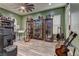 Versatile bonus room designed for entertainment, featuring display cases and guitars for a personalized living space at 12121 Cabo Rojo Ave, Las Vegas, NV 89138
