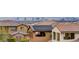 Stunning elevated view of homes with tile roofs and solar panels set against a vibrant city skyline at 12121 Cabo Rojo Ave, Las Vegas, NV 89138