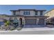 Charming two-story home featuring a tile roof, three-car garage, and manicured front landscaping at 12121 Cabo Rojo Ave, Las Vegas, NV 89138