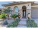 Inviting front entrance with stone accents, desert landscaping and a tiled walkway leading to the front door at 12121 Cabo Rojo Ave, Las Vegas, NV 89138