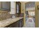 Close up of kitchen area showcasing granite counters, dark cabinets, and mosaic tile backsplash at 12121 Cabo Rojo Ave, Las Vegas, NV 89138