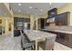 Beautiful kitchen boasting granite countertops, dark cabinets and stainless steel appliances at 12121 Cabo Rojo Ave, Las Vegas, NV 89138