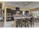 Modern kitchen featuring stainless steel appliances, dark cabinetry, granite counters, and a large center island at 12121 Cabo Rojo Ave, Las Vegas, NV 89138