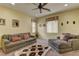 Inviting living room featuring plush seating, neutral walls, and windows offering bright natural light, ideal for relaxation at 12121 Cabo Rojo Ave, Las Vegas, NV 89138