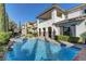 A beautiful swimming pool with a luxurious home in the background at 12121 Cabo Rojo Ave, Las Vegas, NV 89138