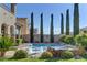 Gorgeous pool with water feature, lush landscaping, and stone accents creating a serene outdoor space at 12121 Cabo Rojo Ave, Las Vegas, NV 89138