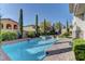 Refreshing swimming pool surrounded by lush greenery and tall, elegant trees at 12121 Cabo Rojo Ave, Las Vegas, NV 89138