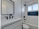 Modern bathroom with white subway tiles, black fixtures, and a framed mirror above the vanity at 1225 Arrowhead Ave, Las Vegas, NV 89106