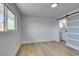 Bright bedroom with light wood floors, white walls, and a sliding barn door to the bathroom at 1225 Arrowhead Ave, Las Vegas, NV 89106