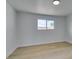 Bedroom with light hardwood floors, white walls, a window, and ample natural light at 1225 Arrowhead Ave, Las Vegas, NV 89106