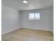 Bedroom with light hardwood floors, neutral walls, and a bright window at 1225 Arrowhead Ave, Las Vegas, NV 89106