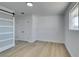 Spacious bedroom featuring light wood floors, white walls, a large window and a sliding door at 1225 Arrowhead Ave, Las Vegas, NV 89106