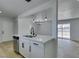 Open kitchen with stainless steel appliances, white cabinets, and a view into the dining area at 1225 Arrowhead Ave, Las Vegas, NV 89106
