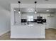 Bright kitchen with white cabinets, black hardware, stainless steel appliances, and modern pendant lighting at 1225 Arrowhead Ave, Las Vegas, NV 89106