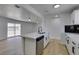 Bright kitchen featuring an island with a sink, stainless steel dishwasher, and light wood floors at 1225 Arrowhead Ave, Las Vegas, NV 89106
