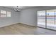 Bright living room boasts new floors, modern lighting, fresh paint, and sliding glass doors to the backyard at 1225 Arrowhead Ave, Las Vegas, NV 89106