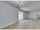 Bright living room features new floors, fresh paint, modern lighting, and sliding glass doors to the backyard at 1225 Arrowhead Ave, Las Vegas, NV 89106