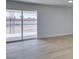 Bright living room featuring light wood floors and sliding glass doors to the patio at 1225 Arrowhead Ave, Las Vegas, NV 89106