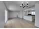 Open living space with new floors, fresh paint, modern lighting, and an open layout to the renovated kitchen at 1225 Arrowhead Ave, Las Vegas, NV 89106