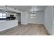 Bright living room features new floors, modern lighting, fresh paint, and an open layout to the kitchen at 1225 Arrowhead Ave, Las Vegas, NV 89106