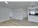 Living area with new floors and a view of the modern kitchen with bar seating at 1225 Arrowhead Ave, Las Vegas, NV 89106