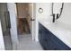 Bathroom featuring double sinks, blue vanity, and walk-in shower at 1624 N Torrey Pines Dr # 101, Las Vegas, NV 89108