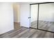 Bright bedroom with light gray wood floors and mirrored closet doors at 1624 N Torrey Pines Dr # 101, Las Vegas, NV 89108