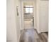 Hallway leading to a bathroom with light gray tile and new fixtures at 1624 N Torrey Pines Dr # 101, Las Vegas, NV 89108
