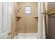 Shower with tile surround, built-in shelving, and a shower curtain at 1732 Cypress Manor Dr, Henderson, NV 89012