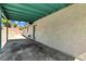 Covered patio area with concrete floor and stucco wall, providing a shady outdoor space at 1775 Esteban Ave, Laughlin, NV 89029