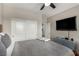 Bedroom with sliding closet doors, neutral walls, a ceiling fan, and wall-mounted TV at 1838 Classic Novel St, Las Vegas, NV 89115