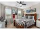 Well-lit bedroom featuring a comfortable bed, soft carpet, and modern ceiling fan at 1838 Classic Novel St, Las Vegas, NV 89115