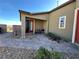 Enclosed back patio with brick pavers, desert landscaping, and sliding glass doors at 2040 Port Royal Dr, Laughlin, NV 89029