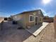 Backyard featuring a large concrete pad, desert landscaping, and fenced perimeter at 2040 Port Royal Dr, Laughlin, NV 89029