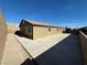 Backyard featuring a large concrete pad, desert landscaping, and fenced perimeter at 2040 Port Royal Dr, Laughlin, NV 89029