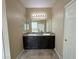 Bathroom featuring double sinks, vanity with dark wood cabinets, and a large mirror, providing a functional space at 2040 Port Royal Dr, Laughlin, NV 89029