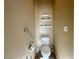Cozy powder room featuring a toilet, grab bar, and wall shelves at 2040 Port Royal Dr, Laughlin, NV 89029