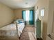 Bedroom featuring carpet, a window with curtains, and a white bed, creating a relaxing and inviting space at 2040 Port Royal Dr, Laughlin, NV 89029