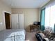Bright bedroom with a desk, futon and window with colored curtains at 2040 Port Royal Dr, Laughlin, NV 89029