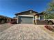 Exterior view of a home with desert landscaping and brick paver driveway at 2040 Port Royal Dr, Laughlin, NV 89029