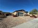 Charming single-story home with neutral stucco and brick accents, complemented by a manicured front yard at 2040 Port Royal Dr, Laughlin, NV 89029