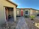 Charming front porch with brick pavers, desert landscaping, and a cozy seating area at 2040 Port Royal Dr, Laughlin, NV 89029