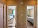 Hallway with views into two bedrooms, each with carpet and decor, provides a glimpse into the home's layout at 2040 Port Royal Dr, Laughlin, NV 89029