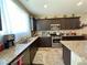 Kitchen with stainless steel appliances, granite counters, and dark cabinets at 2040 Port Royal Dr, Laughlin, NV 89029